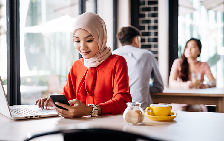 Woman in cafe using her phone