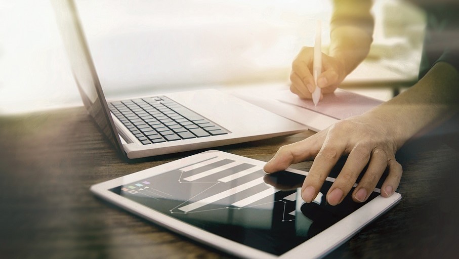 Man working on laptop and tablet